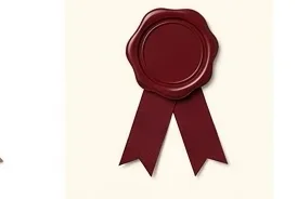 A maroon wax seal pressed on a folded letter, ribbon beneath